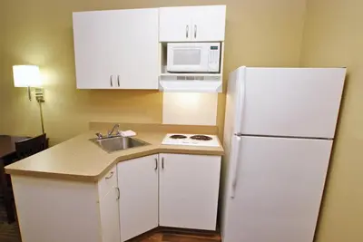 a kitchen with a white refrigerator and a sink at Extended Stay America Suites - New York City - LaGuardia Airport in Queens