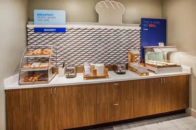 a bakery with a counter with donuts on it at Holiday Inn Express Poughkeepsie by IHG in Poughkeepsie