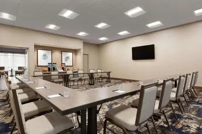 a conference room with a long table and chairs at Tru by Hilton Albany Crossgates Mall in Albany