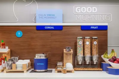 a grocery store with food items on a counter at Holiday Inn Express & Suites Utica by IHG in Utica