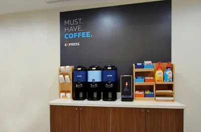 a counter with bottles of coffee on it at Holiday Inn Express & Suites Utica by IHG in Utica