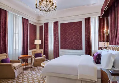a hotel room with a large bed and a chandelier at 5th & 55th Residence Club in New York