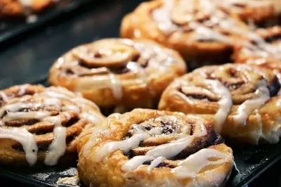 a bunch of donuts with icing on a tray at Holiday Inn Express & Suites Jersey City - Holland Tunnel by IHG in Jersey City