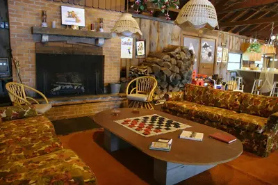 a living room with a chess table and a fireplace at Cabin Deck House - Formidable Cabin in Laurel Island in East Hampton