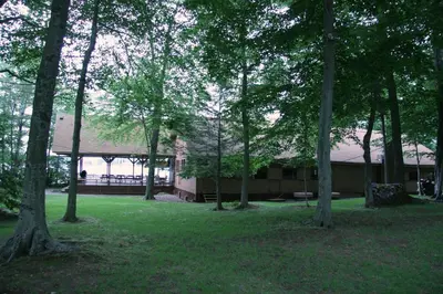 a group of trees in front of a building at Cabin Deck House - Formidable Cabin in Laurel Island in East Hampton