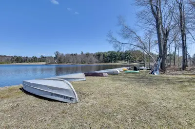 a group of boats sitting on the shore of a lake at Shared Lake Access and Fire Pit Catskills Getaway! in Ellenville