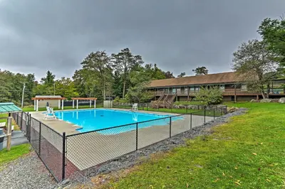 a fence around a swimming pool in a yard at 1 Mi to Lake Family-Friendly Tobyhanna Home in Tobyhanna