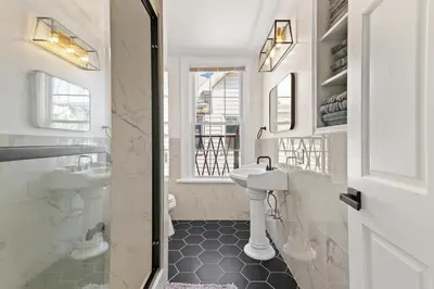 a white bathroom with a sink and a toilet at Cozy Gem in the Heart of East Rock with FREE Parking near Yale and DT in New Haven