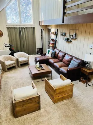 a living room with a leather couch and tables at 4BD 2BA - Mount Snow VT - Ski-Back Trail - Shuttle in Dover