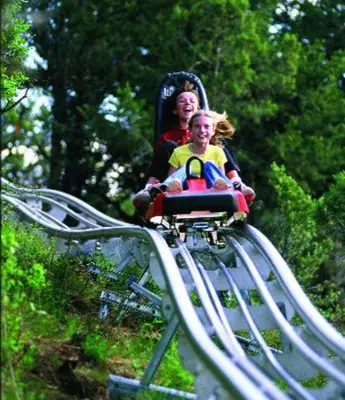 a woman and a child riding on a roller coaster at Gorgeous Ski On/Off 2 BR Sleeps 8 Jiminy-Must See Luxury in Hancock