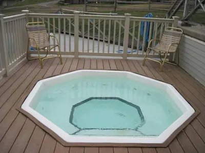 a large swimming pool on a deck with two chairs at Unique Yeti-Theme Ski On Off Suite Jiminy-Sleeps 4 in Hancock