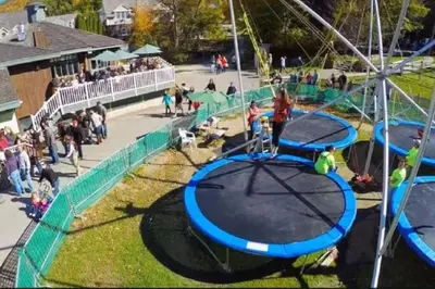 a group of people standing around a playground at Gorgeous New Zen Suite Sleeps 4-Ski On Off Jiminy in Hancock