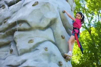 a little girl climbing on a rock wall at Gorgeous New Zen Suite Sleeps 4-Ski On Off Jiminy in Hancock