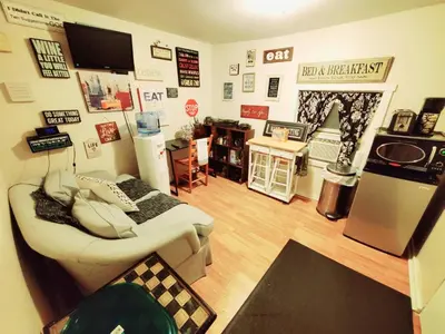 a room with two beds and a kitchen with a fireplace at Black-white Rm By Yale U in New Haven