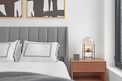 a bedroom with a bed with a gray headboard at 149BK-501 NEW Prime greenpoint 2BR WD in unit in Brooklyn