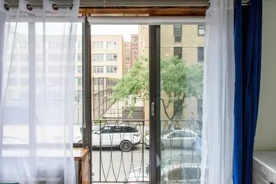 a window with a view of a car on a street at 75-1C New 1BR prime UES W D the unit Best Value in New York