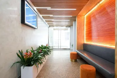 an office hallway with plants and a bench and a window at 75-3C Brand New Duplex 3BR W D in the unit in New York