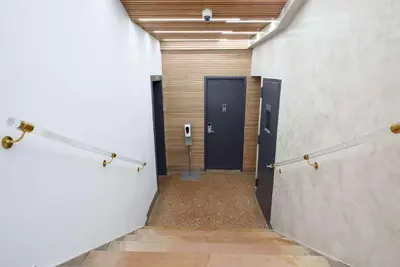 a hallway with a black door in a building at 75-4B Duplex 3BR Brand new W D Prime UES in New York