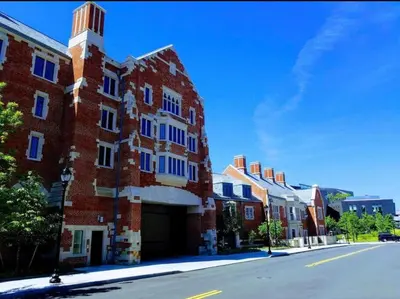 a red brick building with a tower on a street at Peachy Paradise in East Rock Near DT/Yale in New Haven