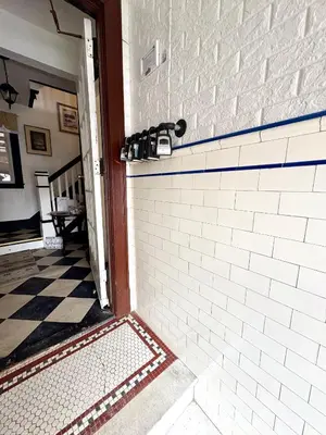 aoyer with a white brick wall and a tile floor at The Jazz Suite B1 in Hartford