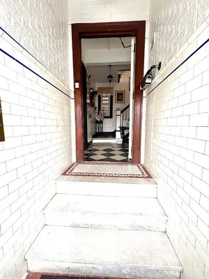 a stairway leading into a hallway with a doorway at The Traveler Suite C1 in Hartford