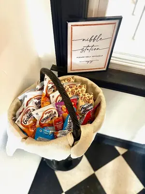 a basket full of candy in front of a window at The Traveler Suite C1 in Hartford
