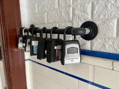 a row of cell phones hanging on a wall at The Traveler Suite C1 in Hartford