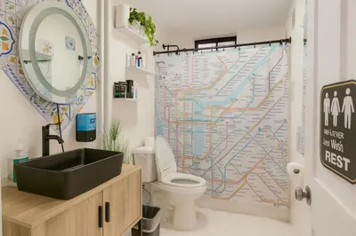 a bathroom with a sink and a map shower curtain at Blue style Room in Guesthouse in New York