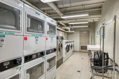 a laundry room with washing machines in a store at Midtown E 2BR w WD nr Central Park NYC-531 in New York
