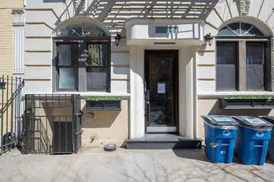 a house with two windows and a door and two trash cans at East Village 1br w wd nr cafes NYC-1115 in New York