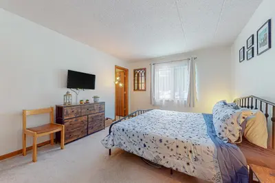 a bedroom with a bed and a tv and a dresser at Mountain Village #5H in Dover