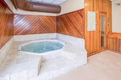 a jacuzzi tub in a room with wooden walls at Mountain Village #5H in Dover
