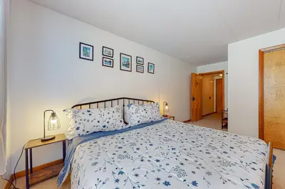 a bedroom with a bed with a blue and white comforter at Mountain Village #5H in Dover