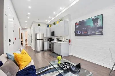 a living room with a couch and a tv on a wall at SWJ 1st - Near Most Attractions Walk to Train Times Sq near in New York