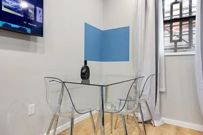 a glass table with two chairs and a vase on it at SWJ G - Save on 2Day or more Stays 25min to Times Sq in New York